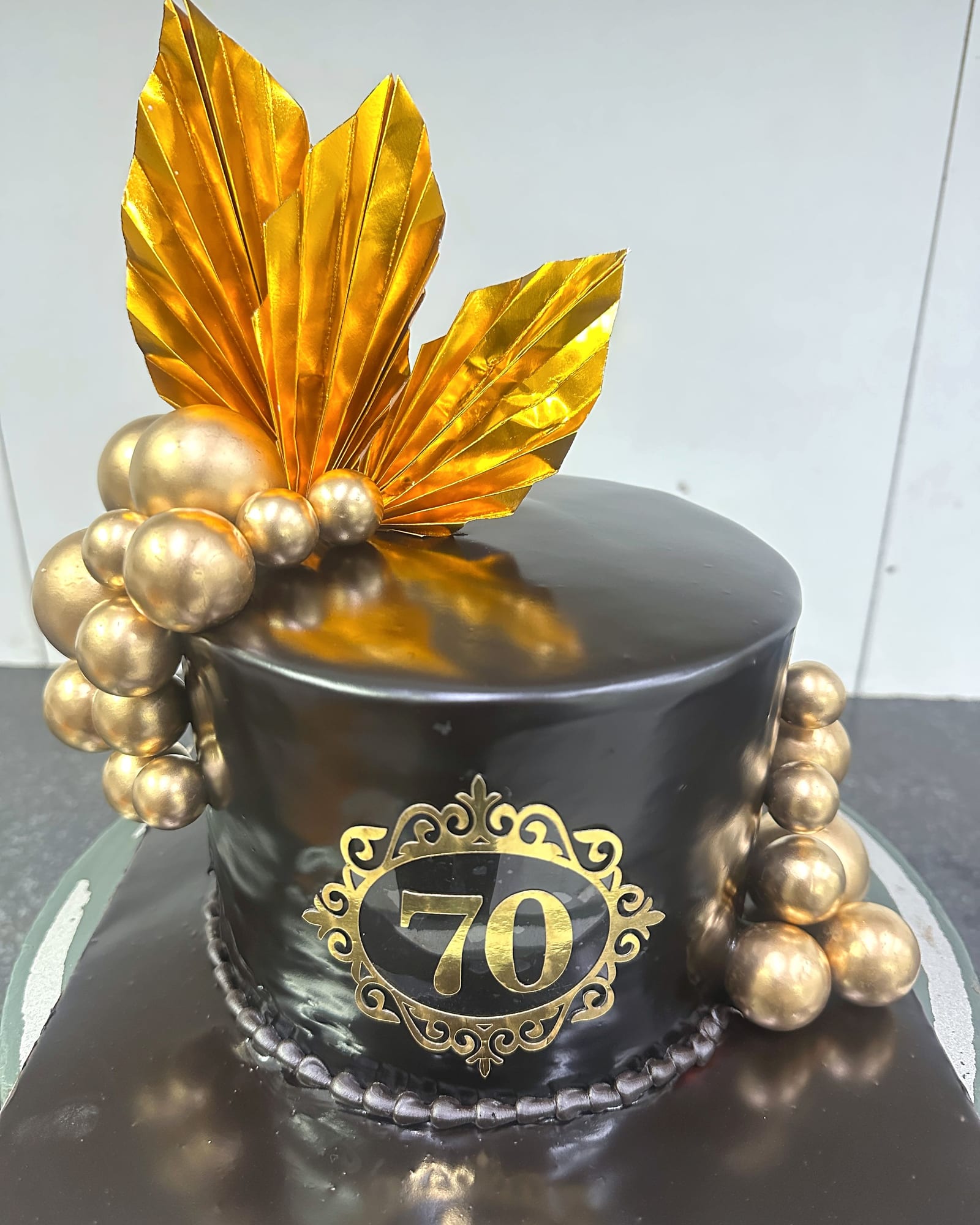 Black and gold seventieth anniversary cake