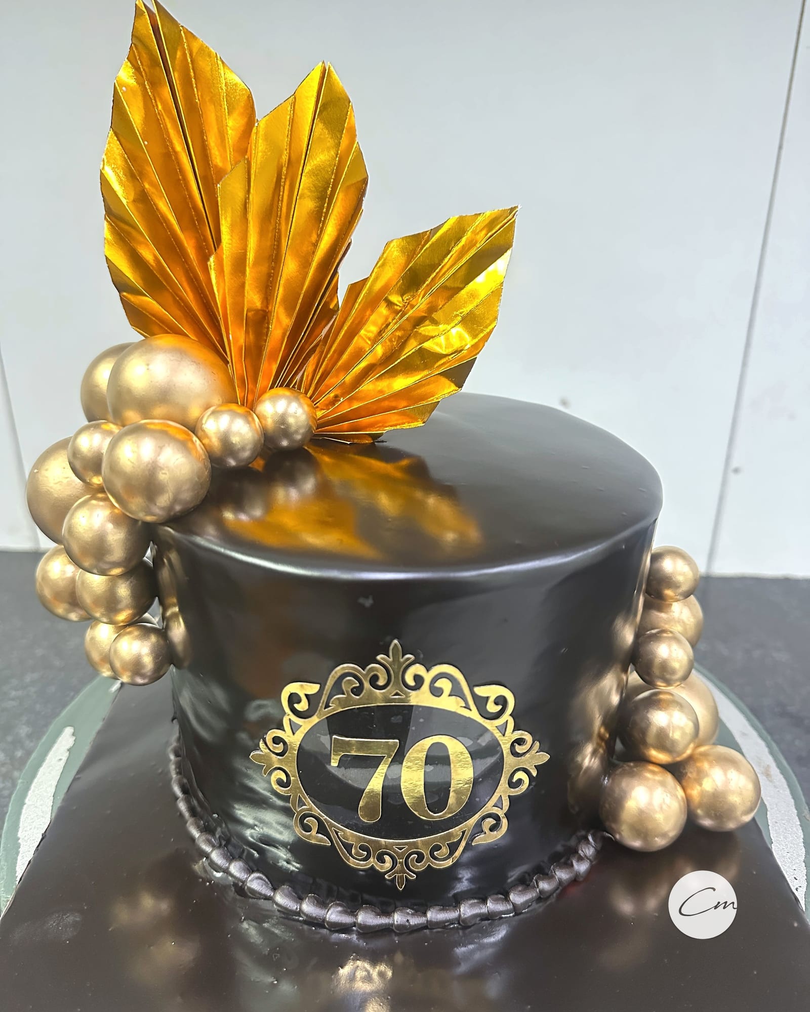 Black and gold seventieth anniversary cake