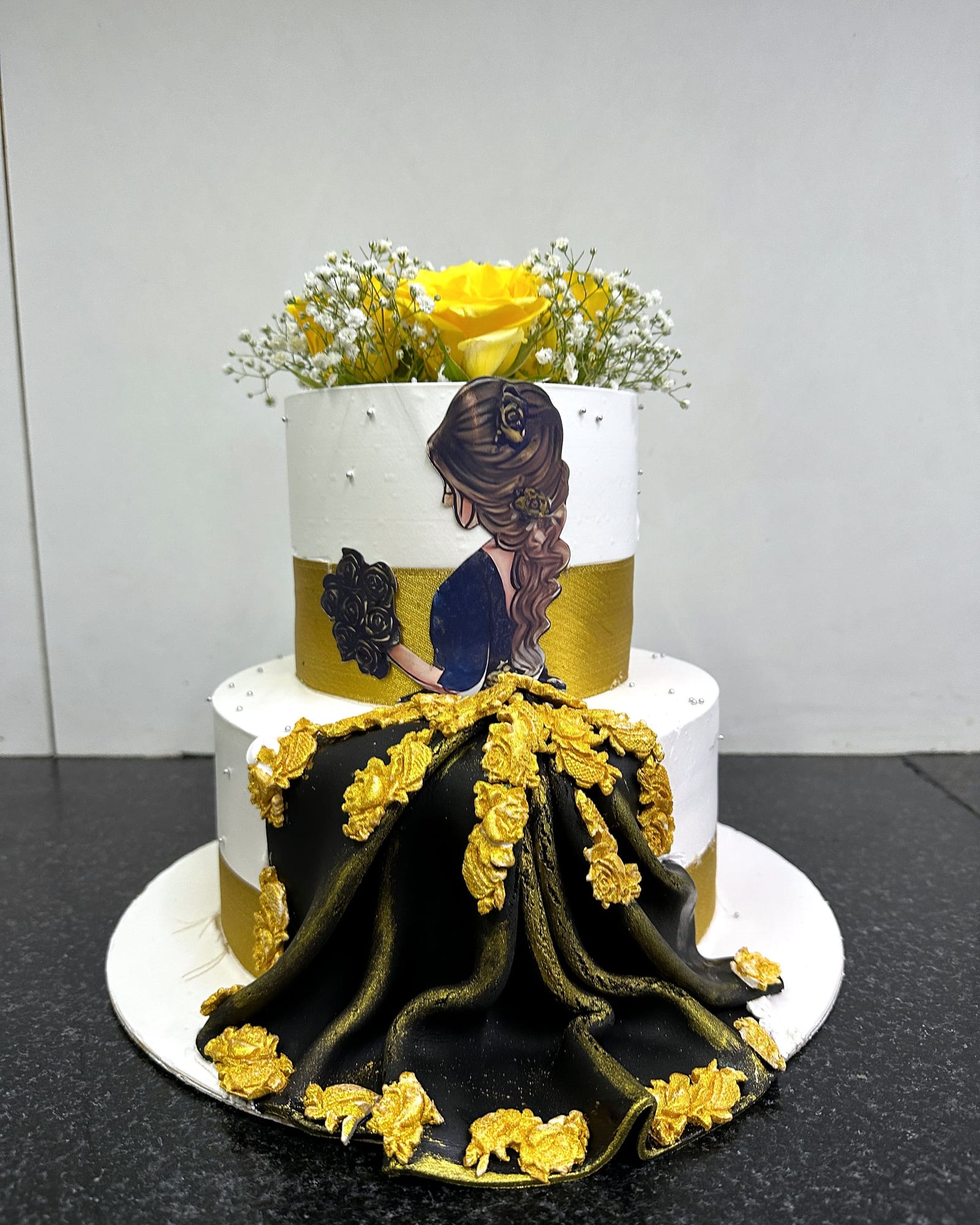 Two-tier bride cake in black and gold
