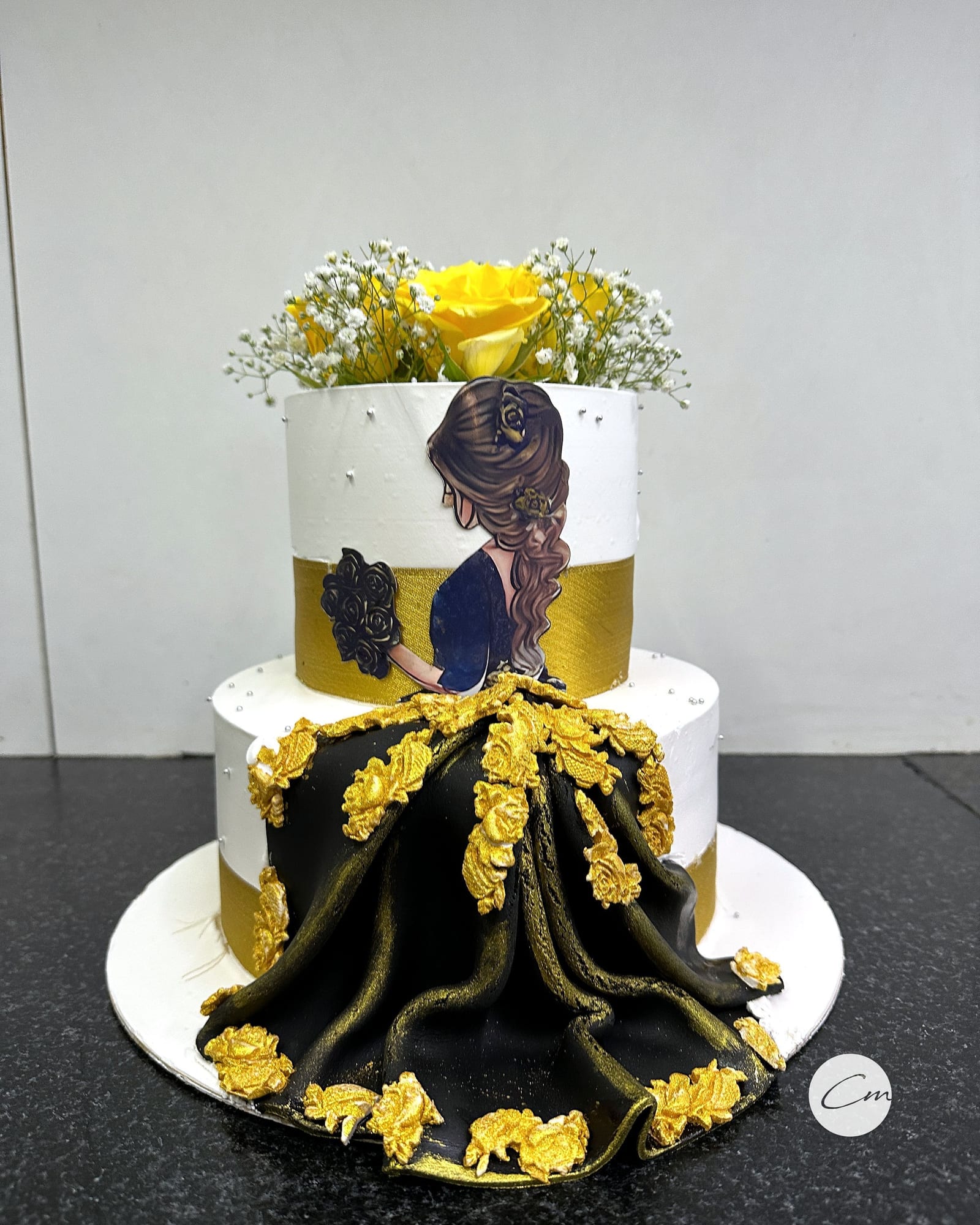 Two-tier bride cake in black and gold