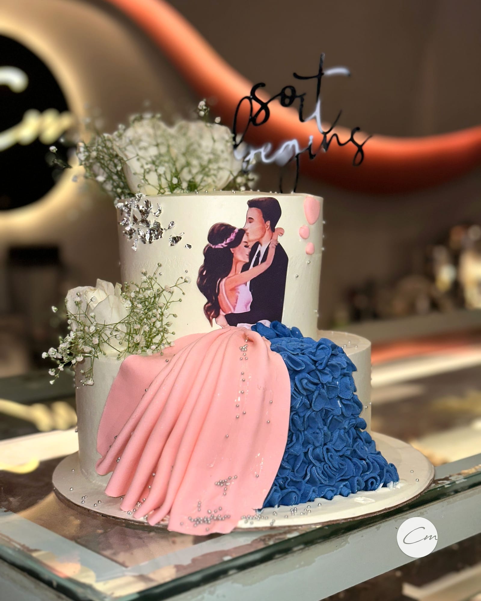 Engagement cake with a hand-piped couple and a ruffled gown