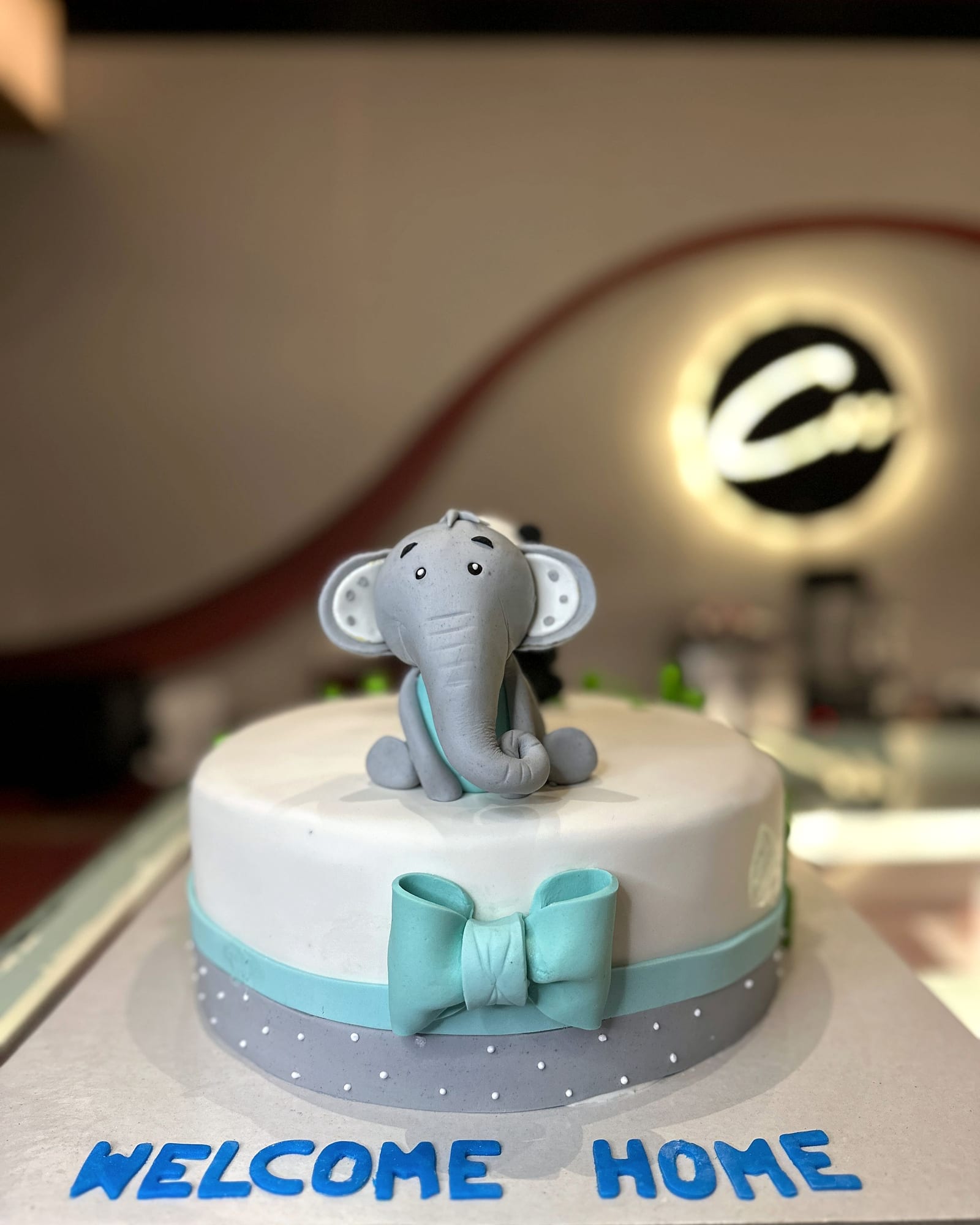Welcome-home cake topped with a hand-modelled fondant elephant