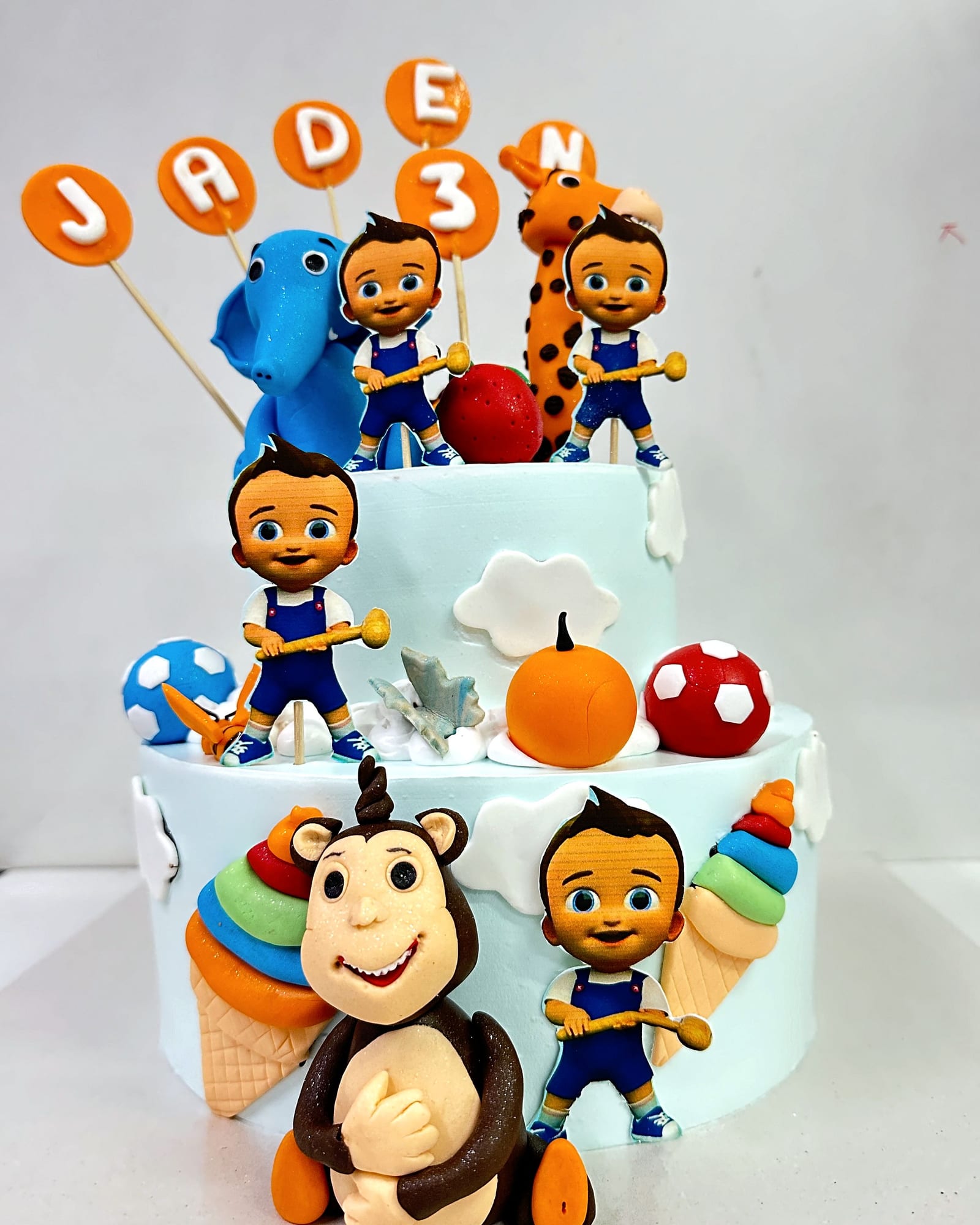 Children's birthday cake crowded with hand-made fondant characters
