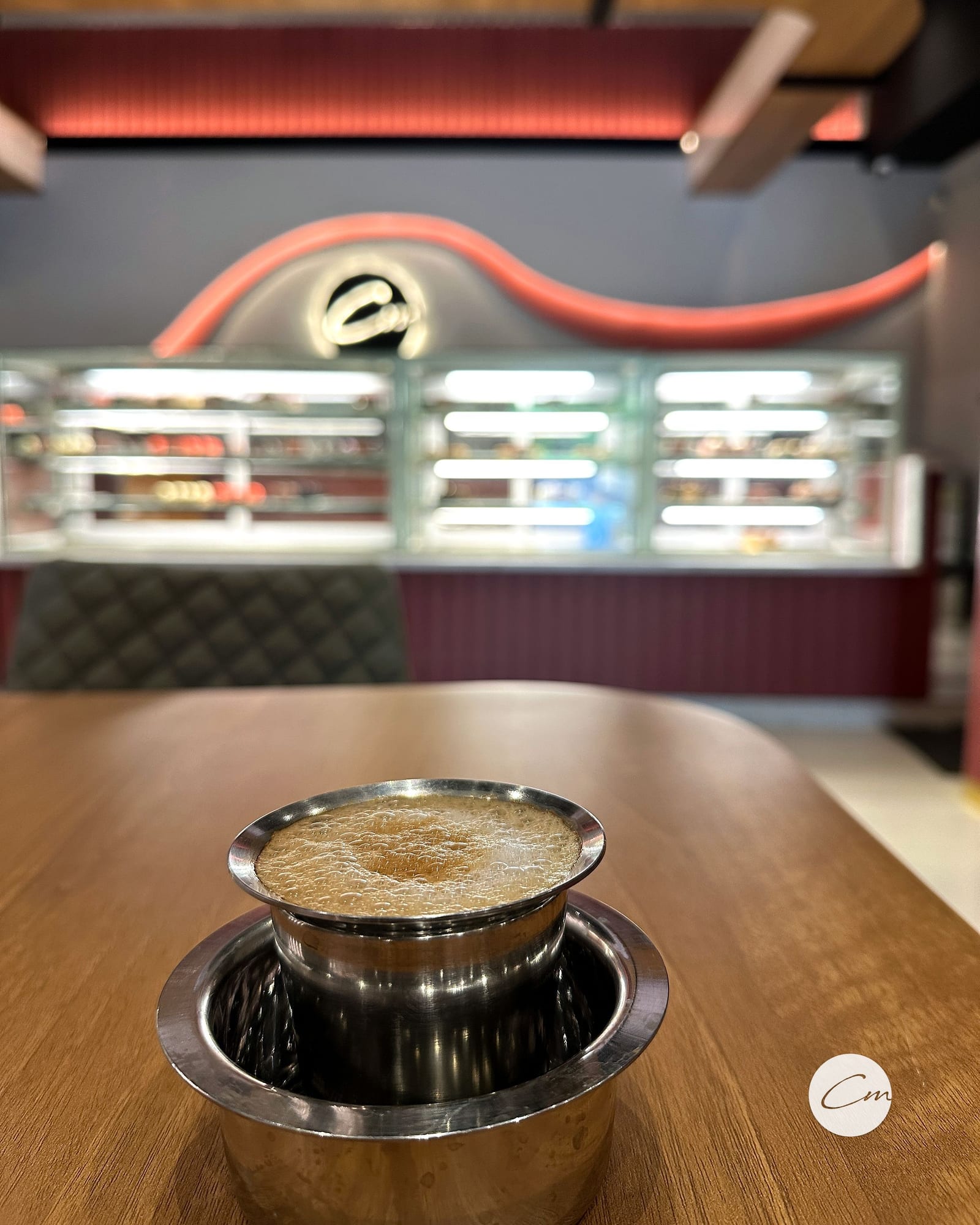 Filter coffee on the table with the dessert counter behind