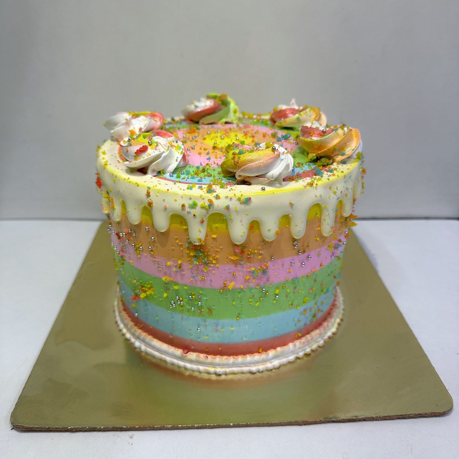 Rainbow layer cake with a white chocolate drip