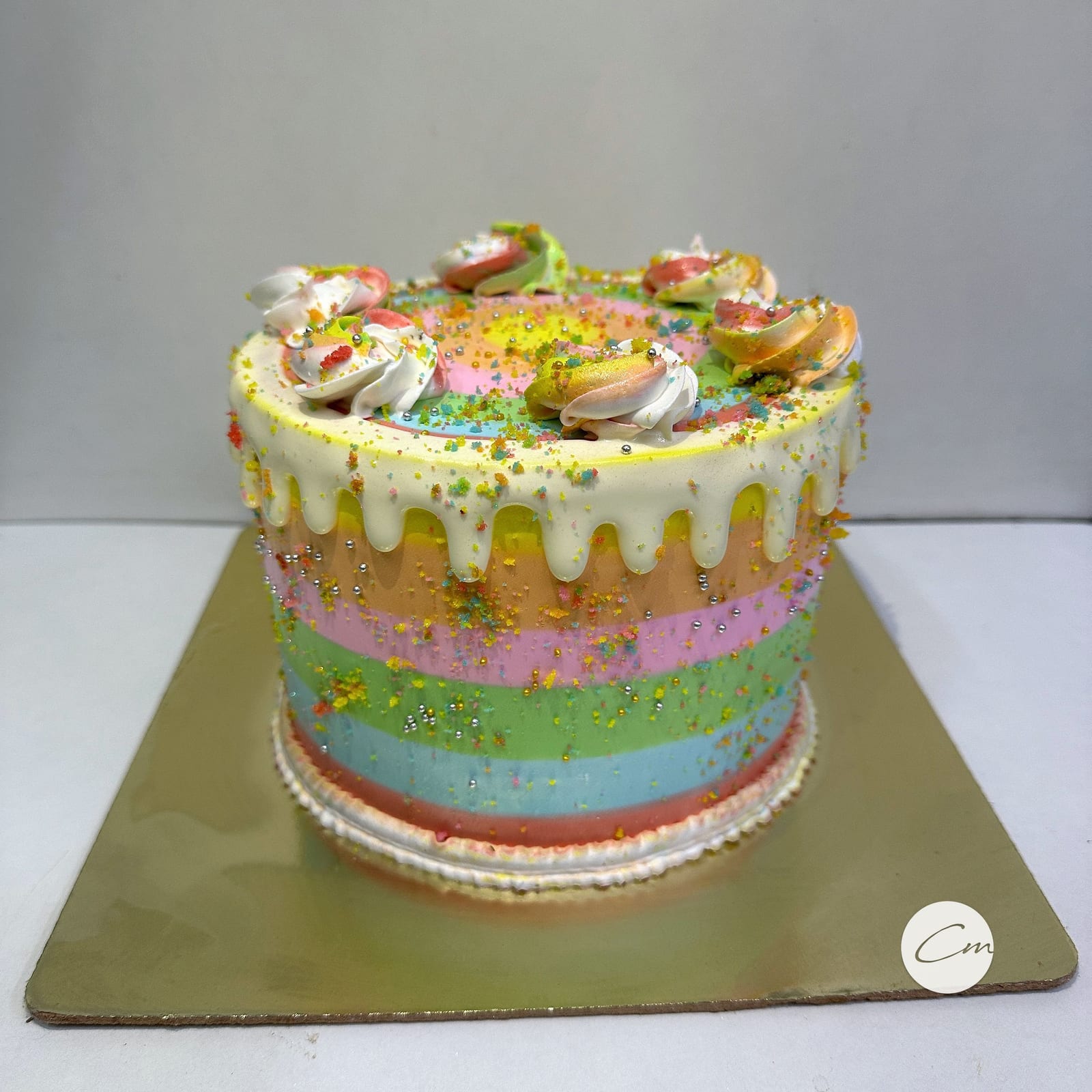 Rainbow layer cake with a white chocolate drip