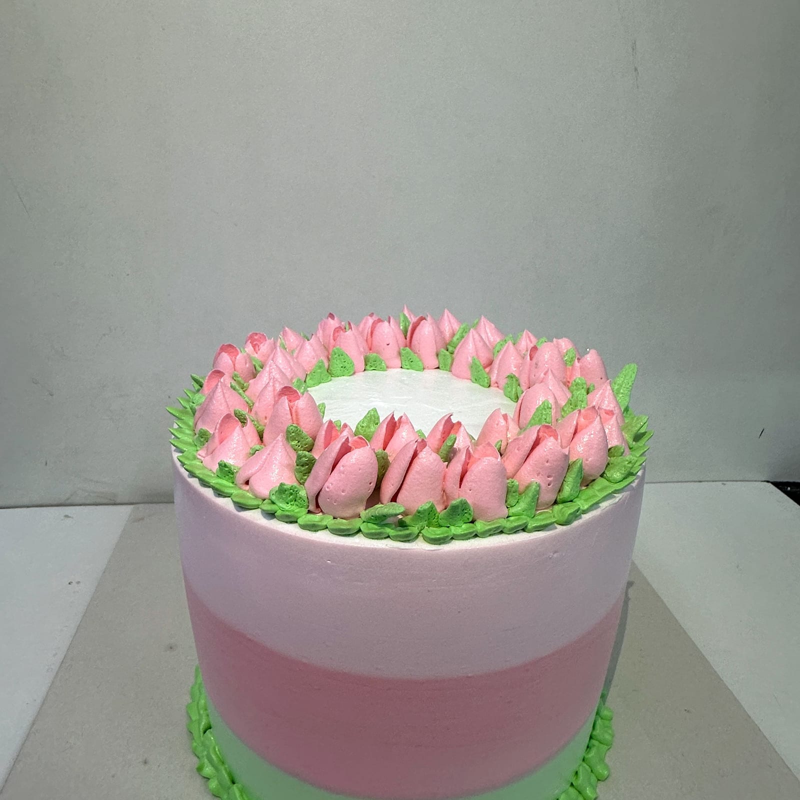 Rose and pistachio cake piped with buttercream tulips