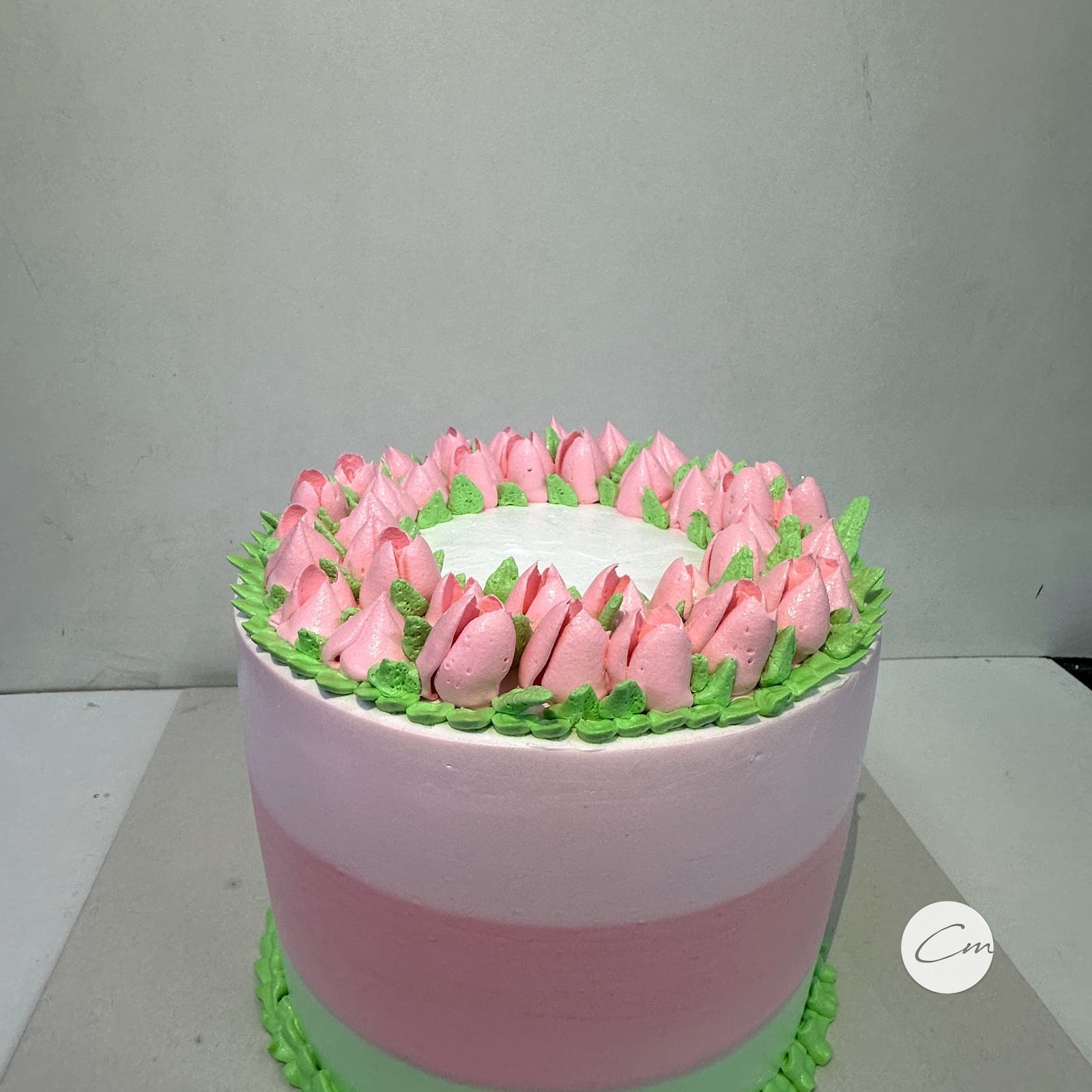 Rose and pistachio cake piped with buttercream tulips
