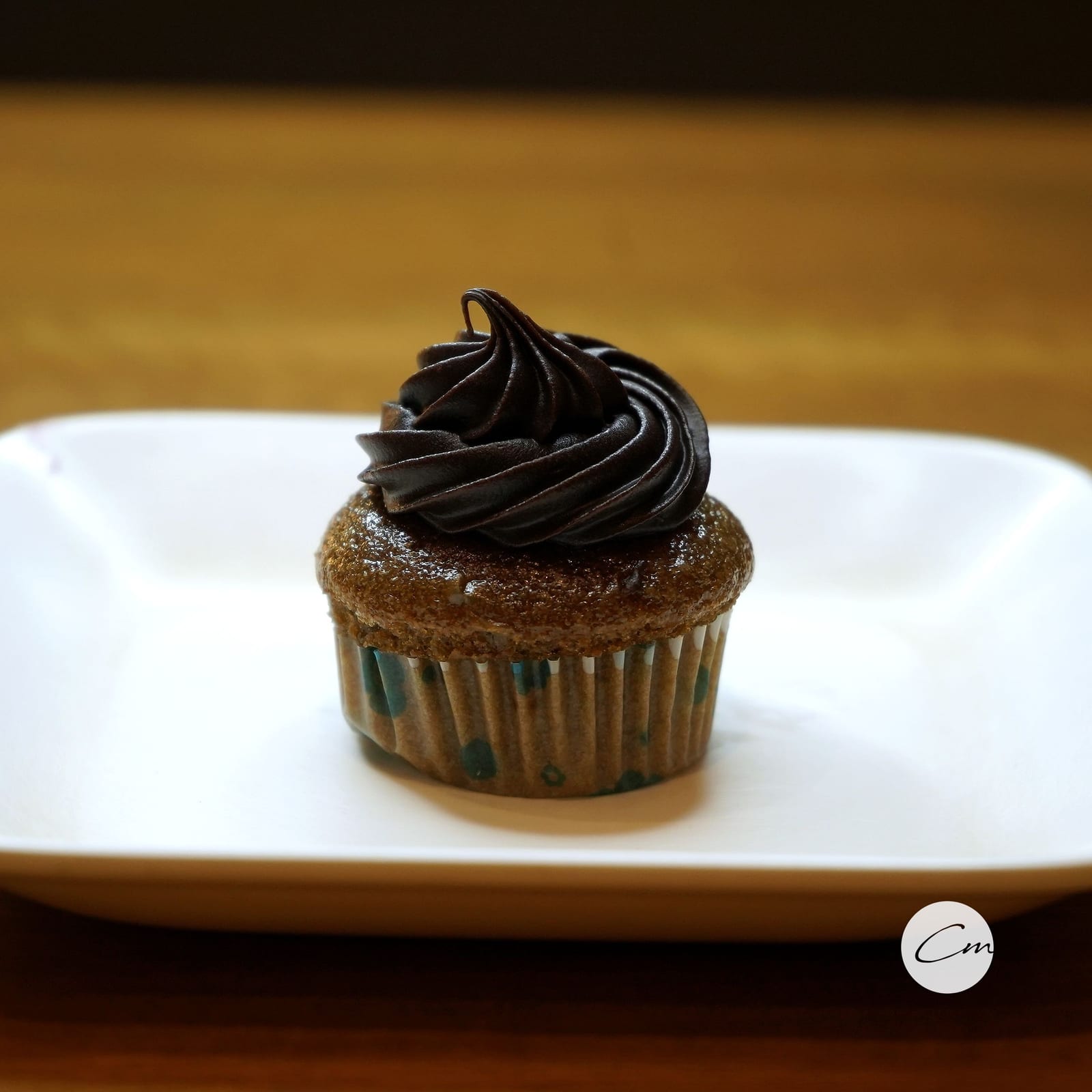 A chocolate cupcake with a dark ganache swirl