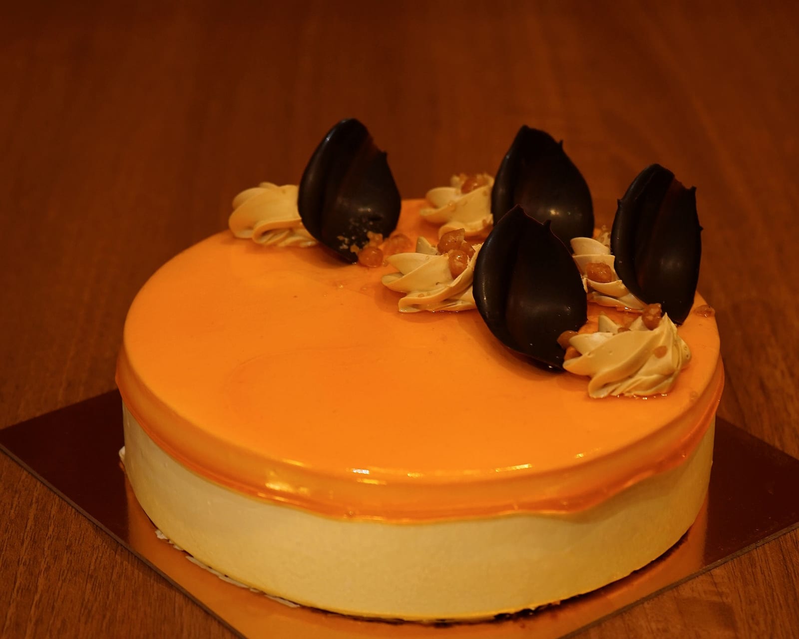A whole eggless mango gateau finished with a mirror glaze
