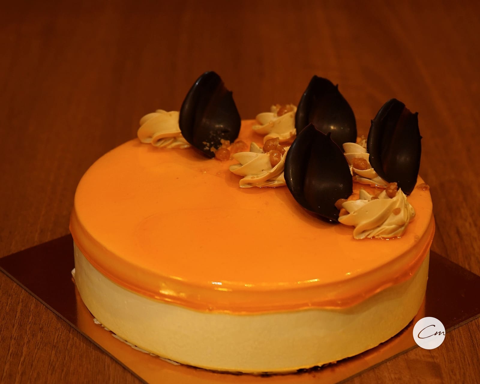 A whole eggless mango gateau finished with a mirror glaze