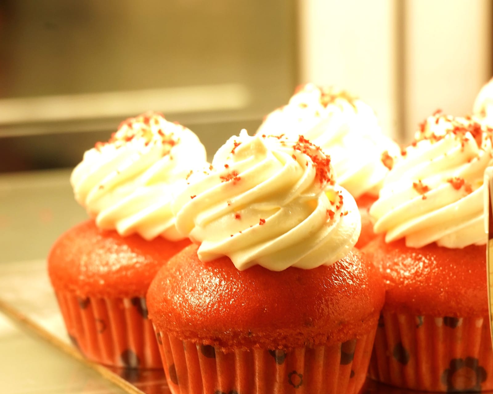 Red velvet cupcakes piped with cream cheese frosting