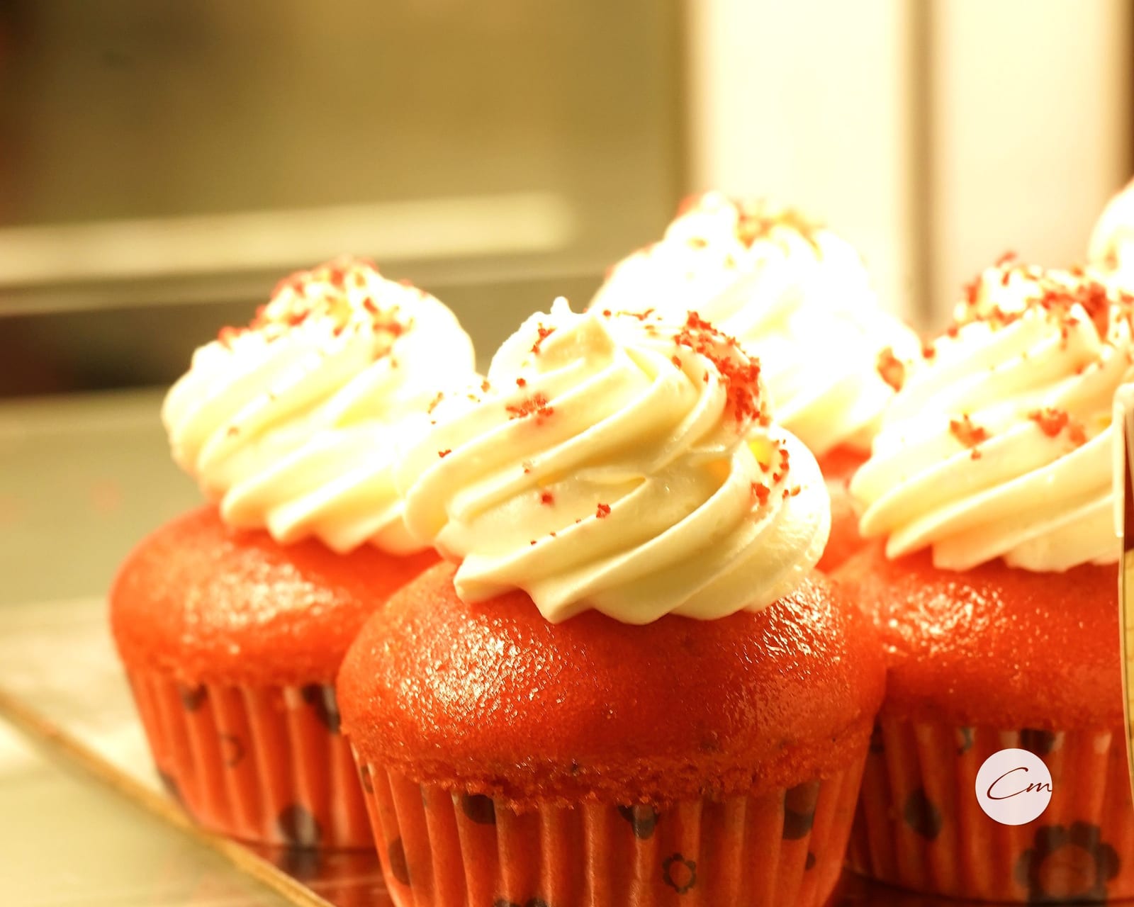 Red velvet cupcakes piped with cream cheese frosting