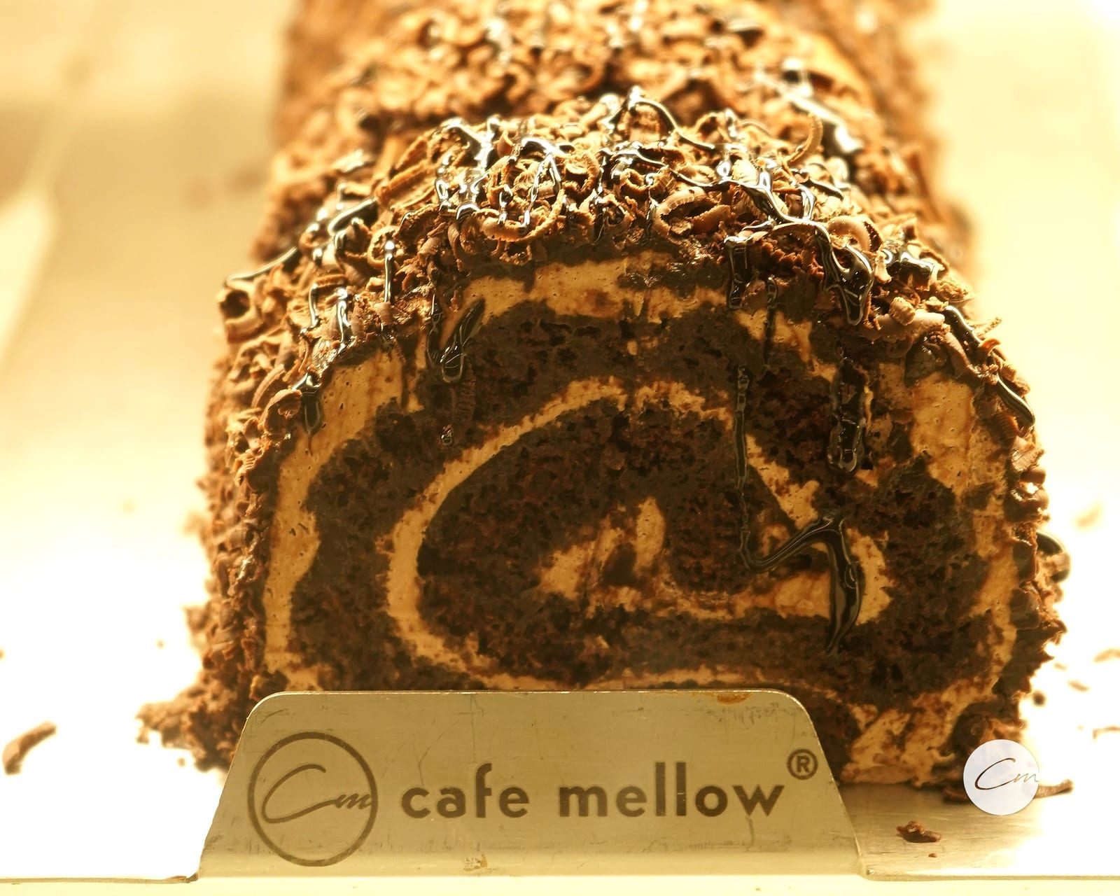 Swiss roll, chocolate sponge and cream, on the Café Mellow counter