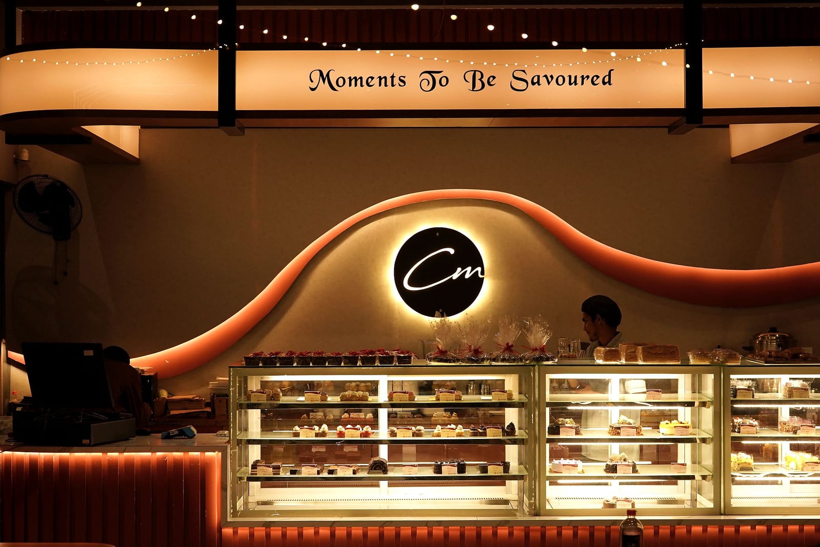 The dessert counter and wave wall at Café Mellow