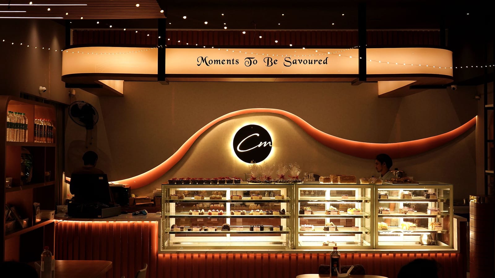Inside Café Mellow — the signature wave wall, counter and banquette seating