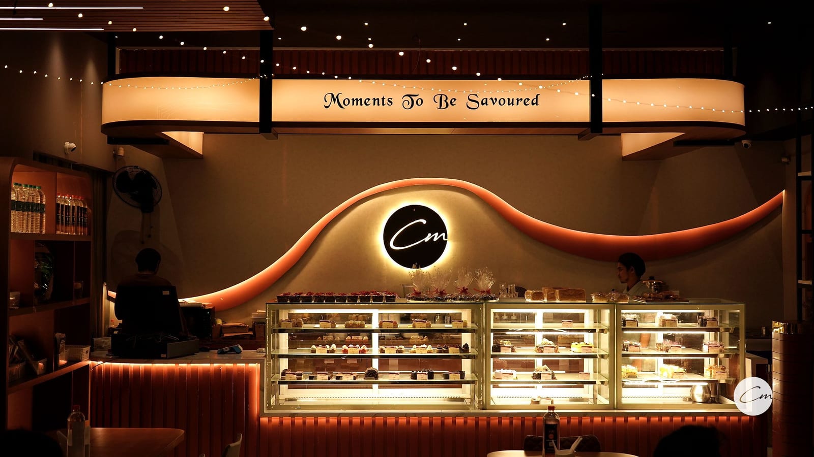 Inside Café Mellow — the signature wave wall, counter and banquette seating