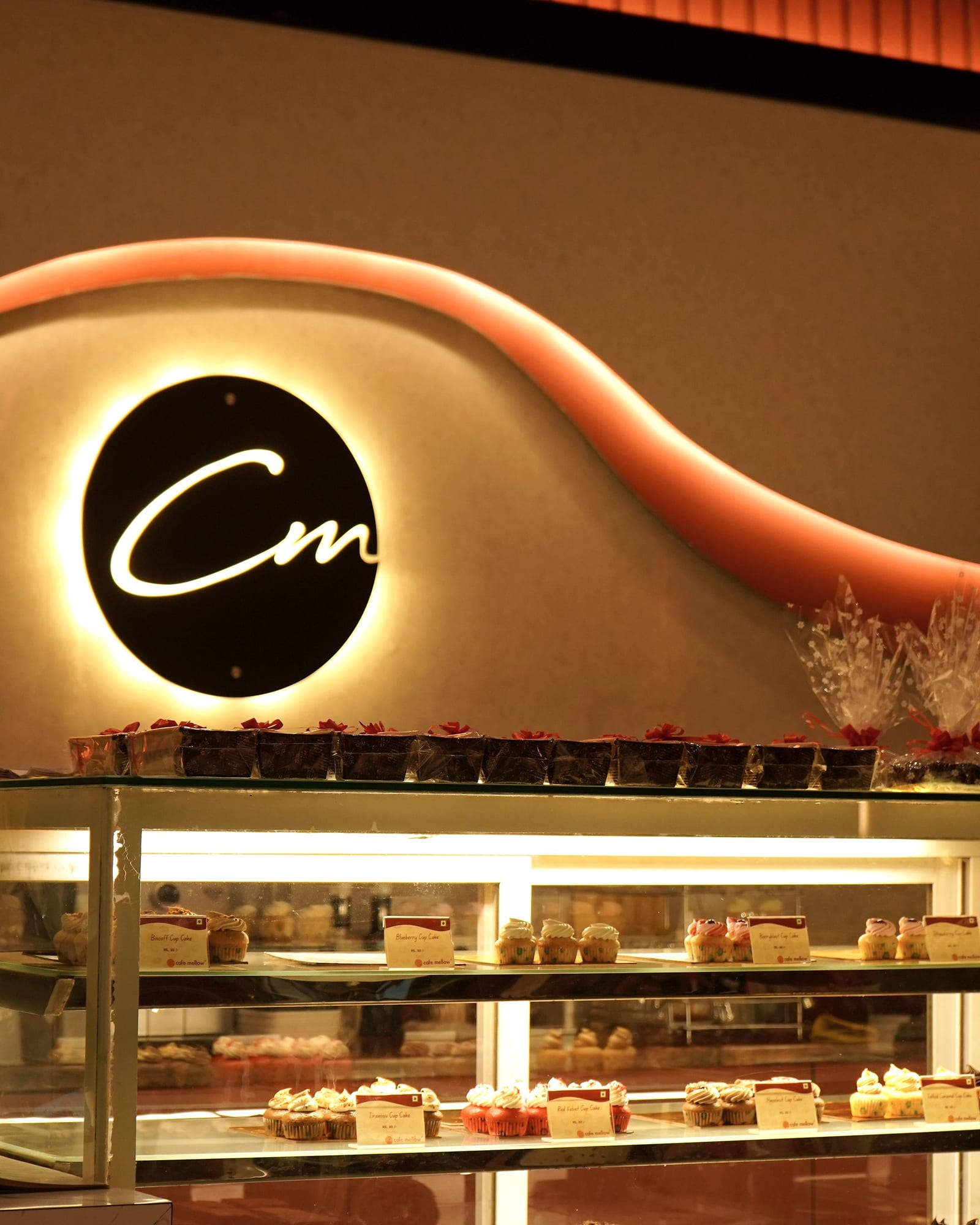 The backlit Café Mellow monogram above the pastry counter