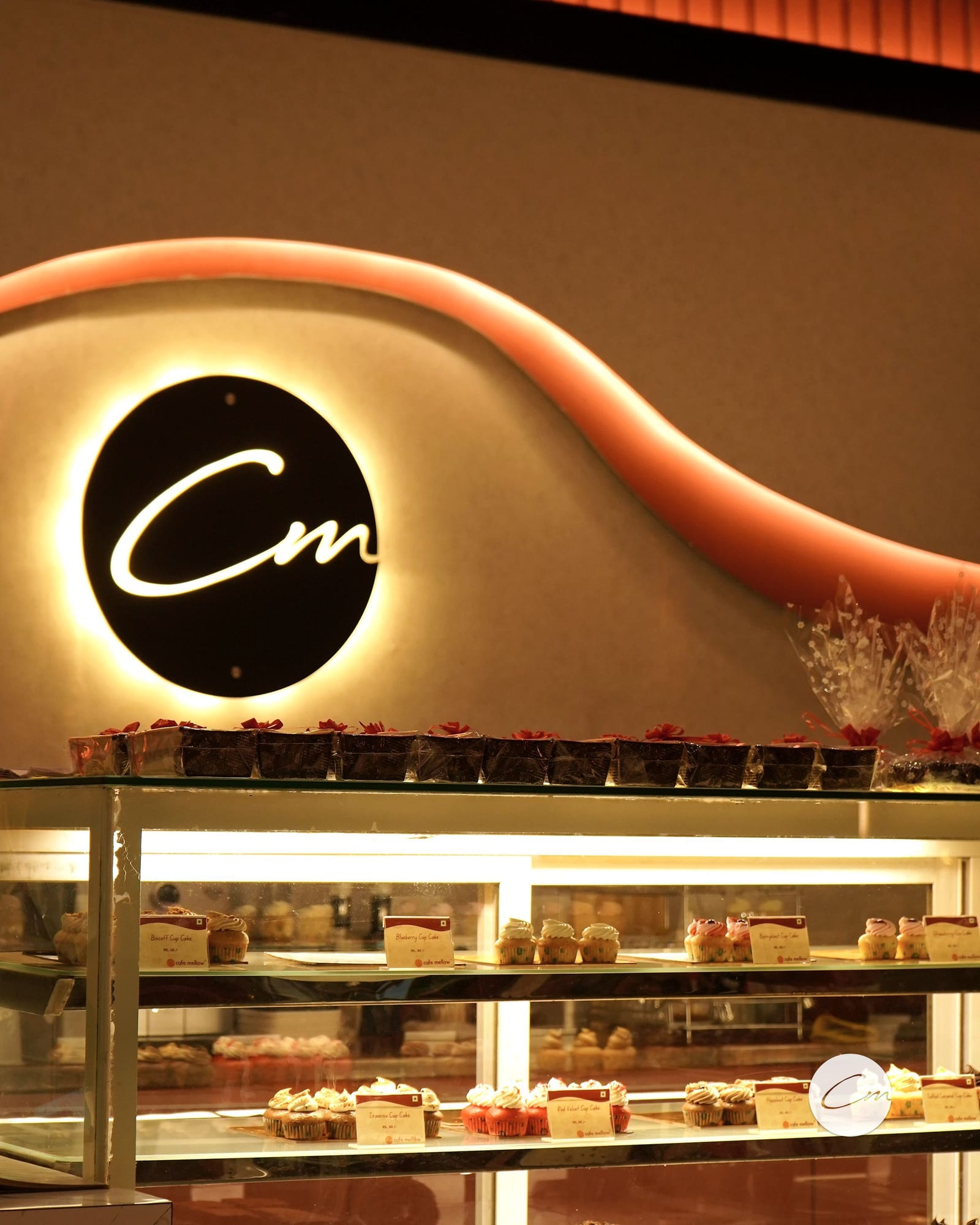 The backlit Café Mellow monogram above the pastry counter